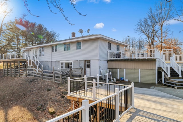 rear view of house featuring a wooden deck