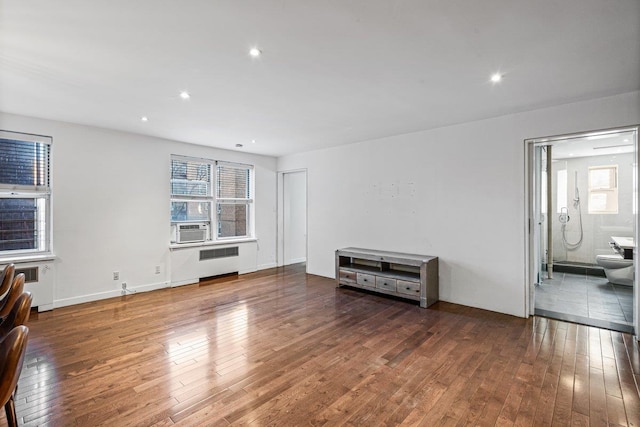 living room with dark hardwood / wood-style flooring and a wealth of natural light