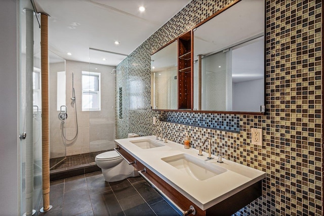 bathroom with decorative backsplash, toilet, sink, and tile walls