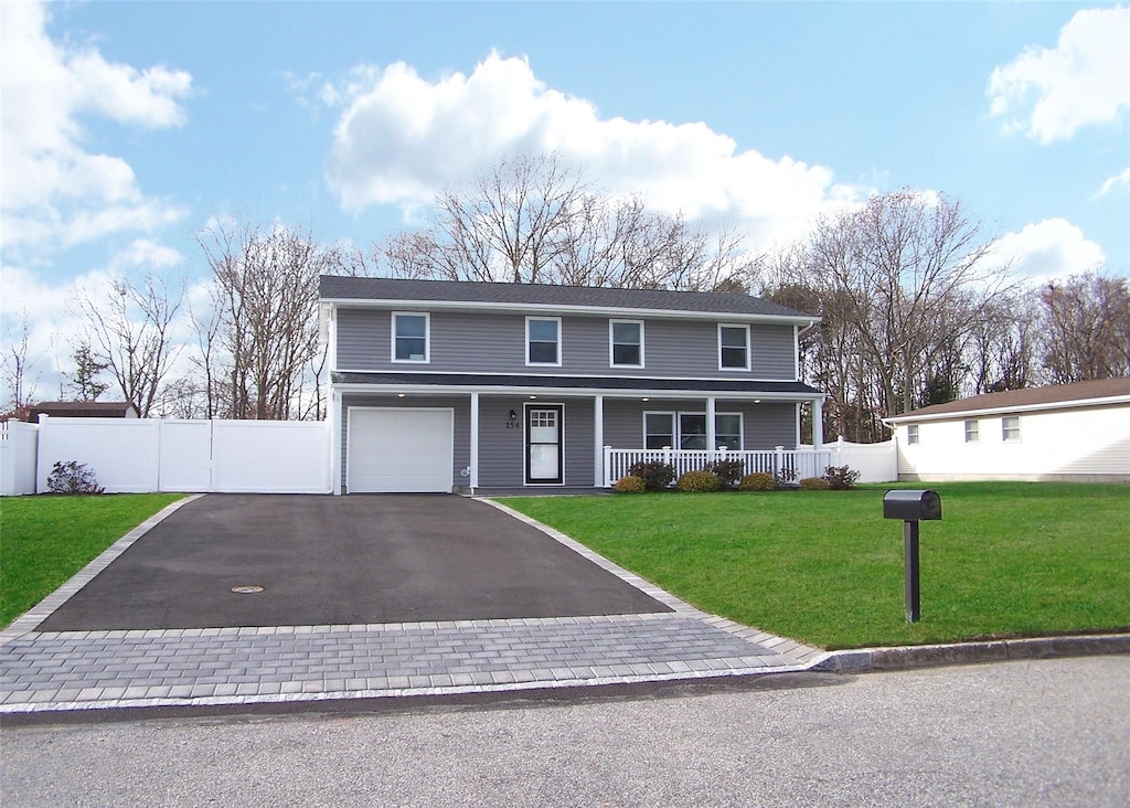 view of front property with a front yard, a porch, and a garage