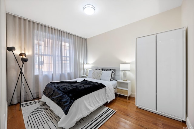 bedroom with a closet and hardwood / wood-style floors