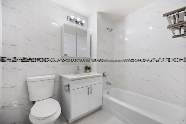 full bathroom with tiled shower / bath, vanity, tile walls, and toilet