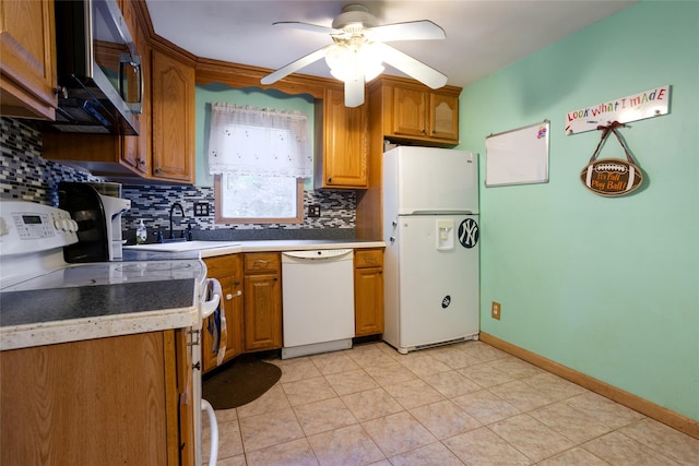 kitchen with sink, white appliances, ceiling fan, and backsplash