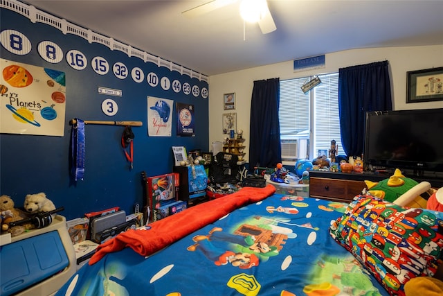 bedroom with ceiling fan and cooling unit