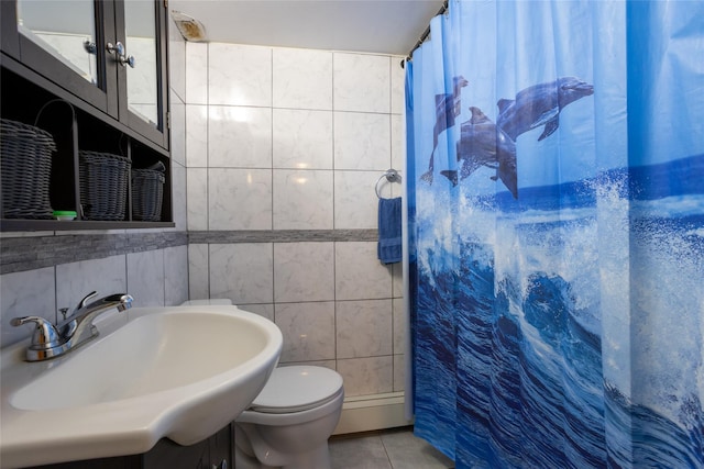 bathroom featuring sink, tile patterned floors, toilet, tile walls, and a shower with shower curtain