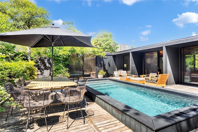 view of swimming pool featuring a wooden deck