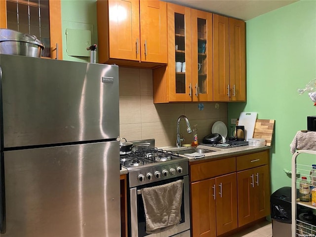 kitchen featuring tasteful backsplash, sink, and appliances with stainless steel finishes