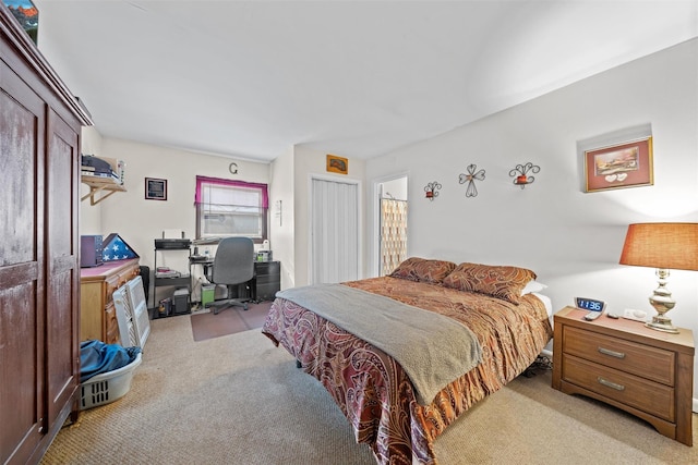 bedroom with light carpet and a closet