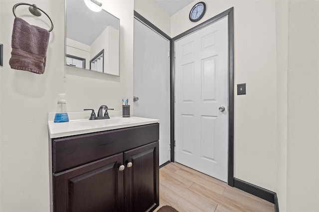 bathroom featuring hardwood / wood-style floors and vanity