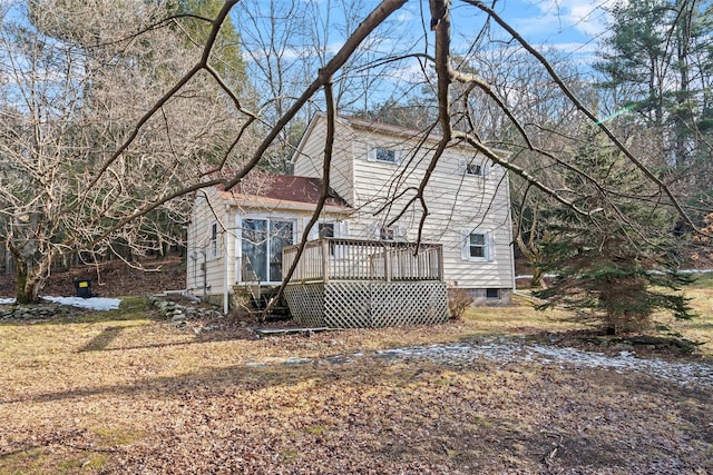 back of property featuring a wooden deck