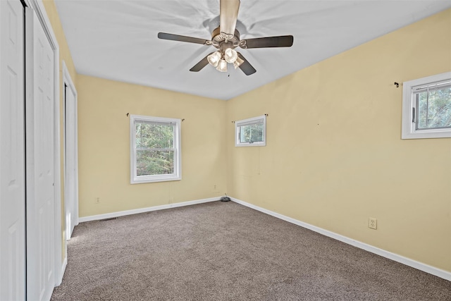 unfurnished bedroom featuring a ceiling fan, a closet, baseboards, and carpet flooring