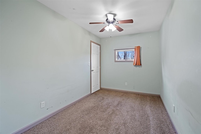 empty room featuring carpet, baseboards, and a ceiling fan