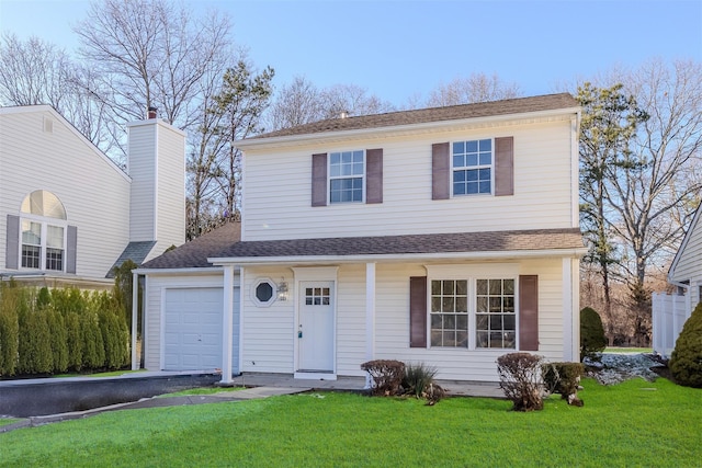 front facade with a front lawn and a garage