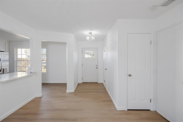 entryway with light hardwood / wood-style flooring