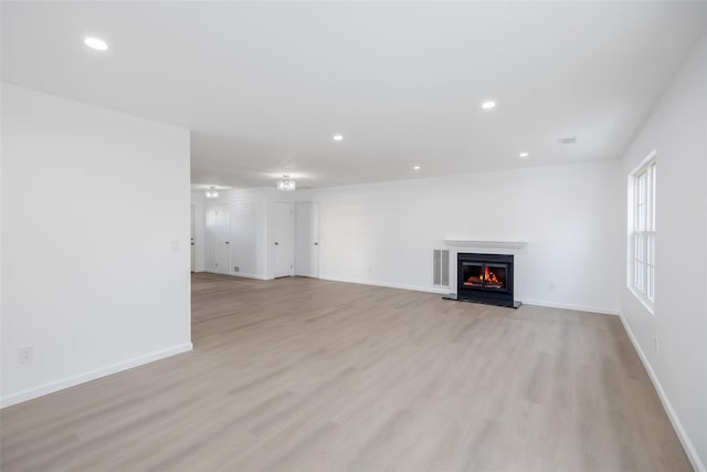 unfurnished living room with light wood-type flooring