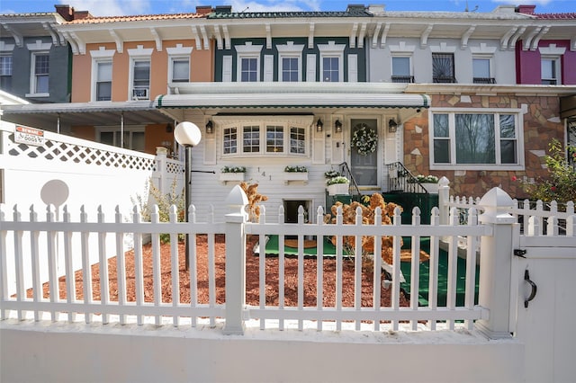 view of front facade featuring a fenced front yard and a chimney