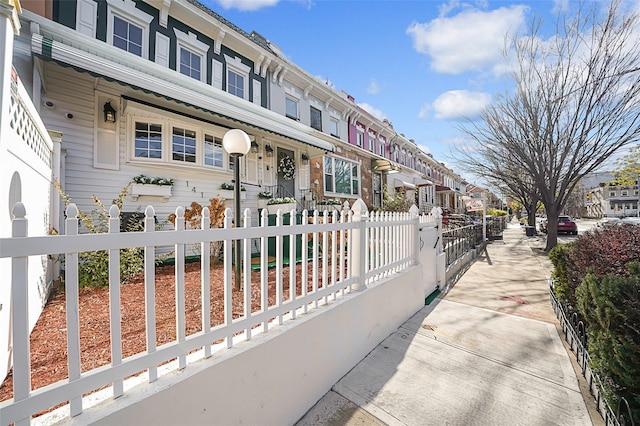 view of property's community with a fenced front yard and a residential view