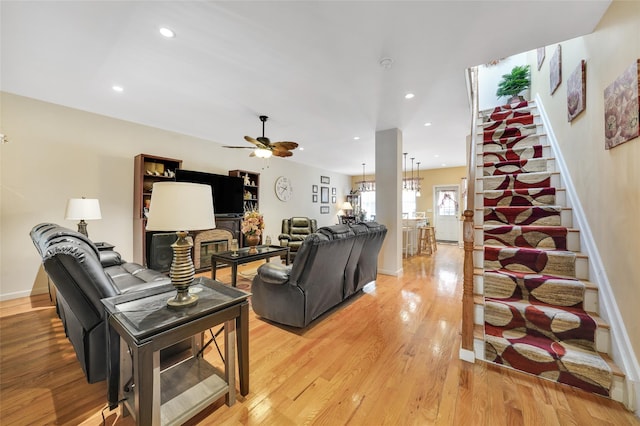 living room with ceiling fan and light wood-type flooring