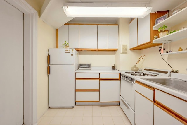 kitchen featuring white cabinetry and white appliances