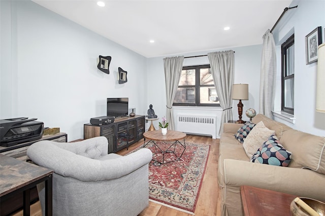 living room with radiator heating unit and hardwood / wood-style flooring