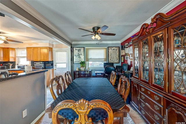 dining space with crown molding, ceiling fan, and light hardwood / wood-style floors