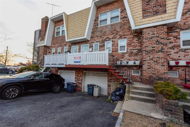 rear view of property with a garage