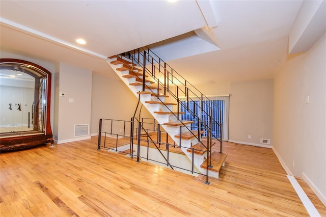 staircase with wood-type flooring