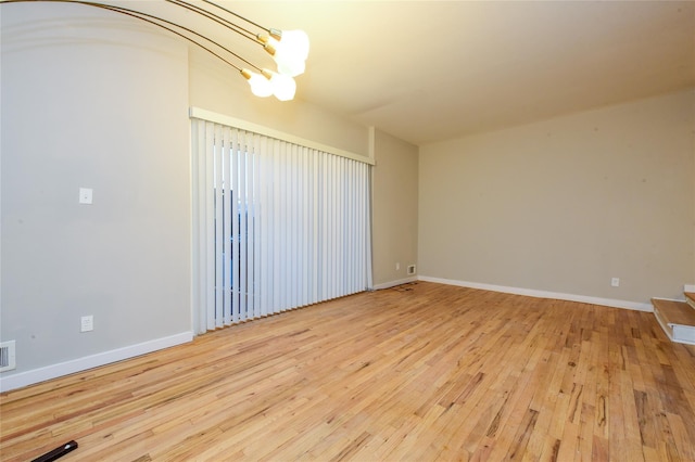 unfurnished room with hardwood / wood-style flooring