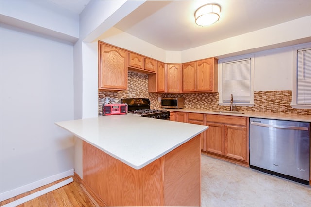 kitchen featuring kitchen peninsula, decorative backsplash, and stainless steel appliances