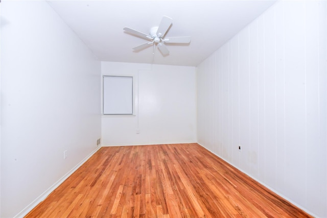 empty room featuring ceiling fan and light hardwood / wood-style flooring