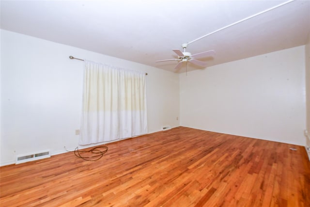 spare room featuring hardwood / wood-style floors and ceiling fan