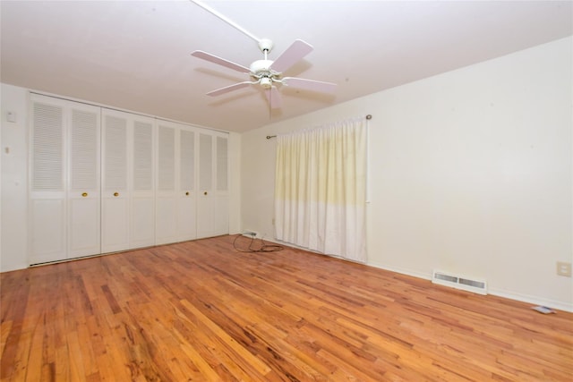 unfurnished bedroom with ceiling fan and light hardwood / wood-style floors