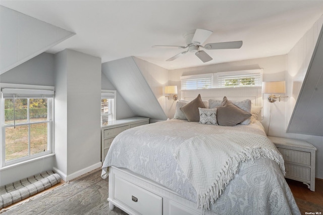bedroom with baseboards, lofted ceiling, ceiling fan, and wood finished floors