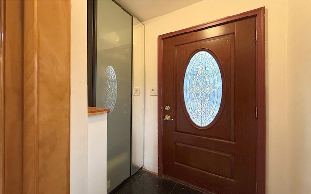 entrance foyer with dark tile patterned flooring