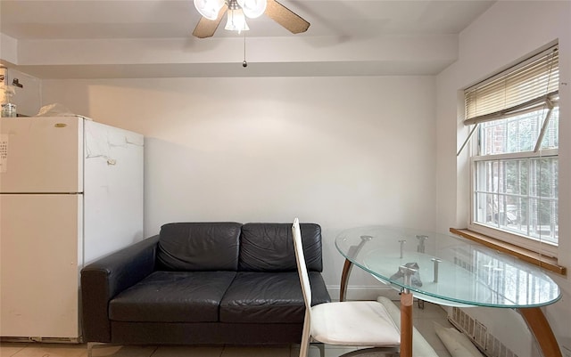 living room featuring ceiling fan and light tile patterned flooring