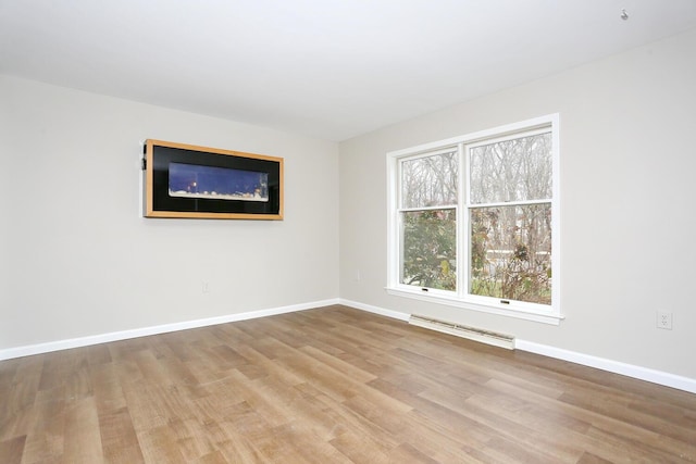 unfurnished room with light hardwood / wood-style flooring