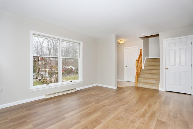 spare room with light hardwood / wood-style flooring and a healthy amount of sunlight