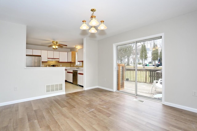 unfurnished living room with ceiling fan with notable chandelier, light wood-type flooring, and sink