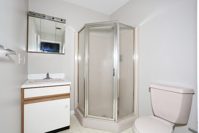 bathroom with vanity, toilet, and an enclosed shower