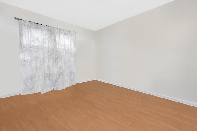 empty room with hardwood / wood-style floors