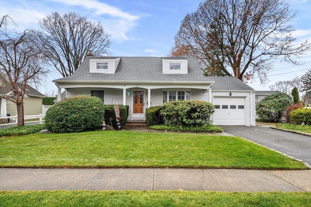 new england style home with a garage and a front lawn