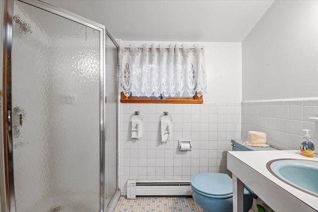 bathroom with tile patterned flooring, toilet, tile walls, walk in shower, and a baseboard radiator