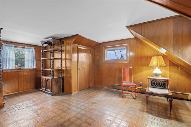 unfurnished room featuring wood walls and a wealth of natural light