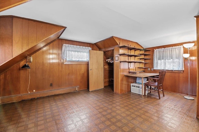 kitchen featuring wood walls, baseboard heating, and vaulted ceiling