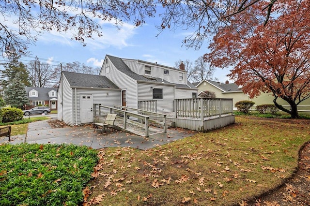 back of house with a yard, a patio, and a deck