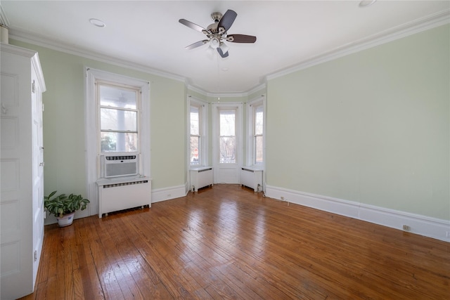 unfurnished room featuring hardwood / wood-style floors, radiator, crown molding, and ceiling fan