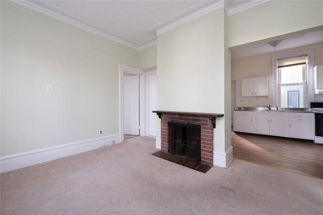 unfurnished living room featuring carpet, ornamental molding, and a brick fireplace