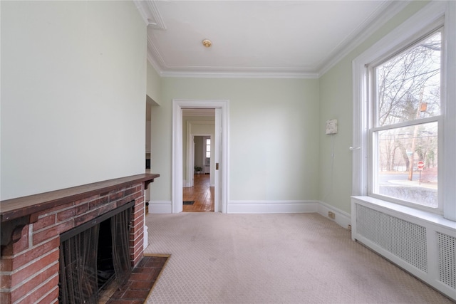 unfurnished living room with carpet flooring, a wealth of natural light, radiator, and ornamental molding