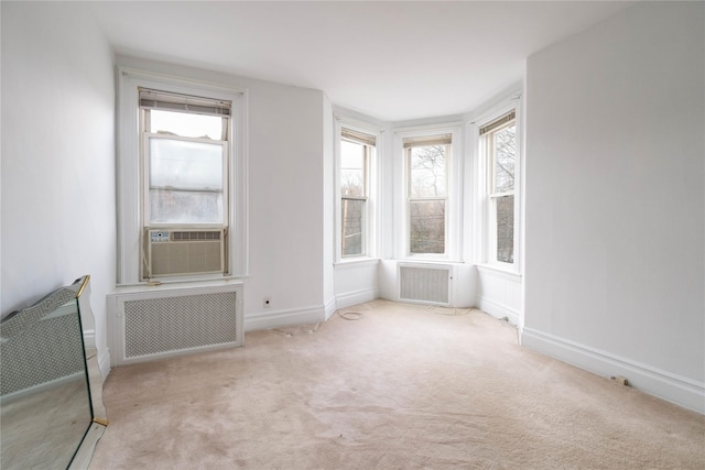 carpeted empty room with radiator heating unit