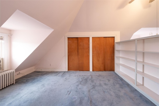 bonus room with ceiling fan, radiator heating unit, carpet floors, and lofted ceiling